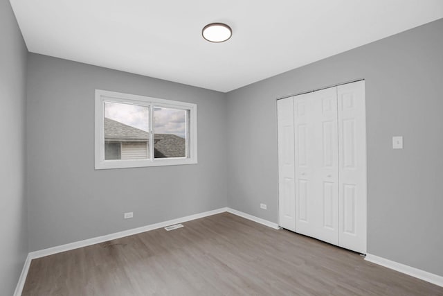 18008 Crawford Ave, Country Club Hills, IL 60478 - unfurnished bedroom featuring wood finished floors, baseboards, and a closet