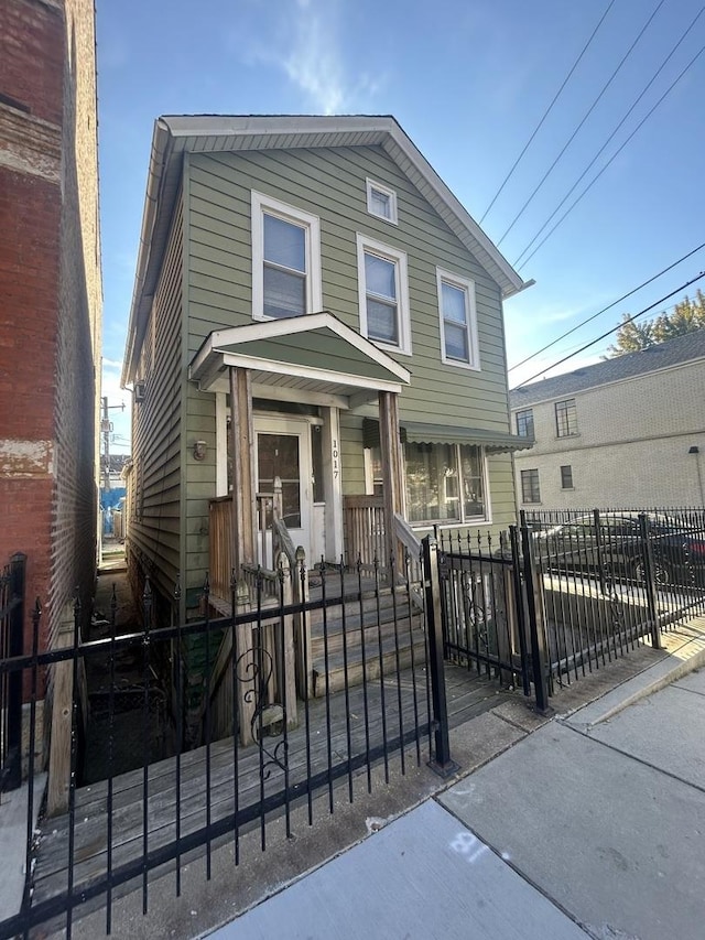 view of front of house with a fenced front yard and a gate