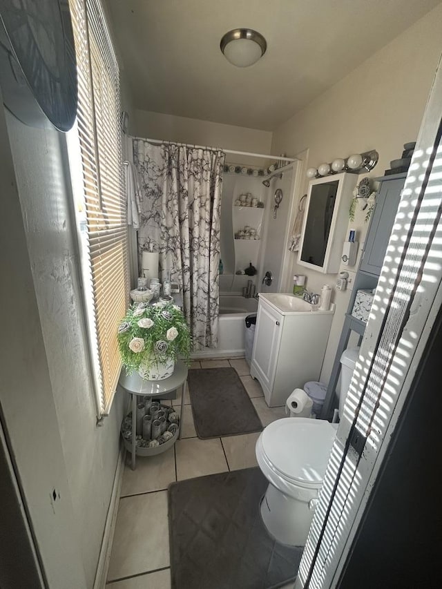 bathroom with shower / bath combo with shower curtain, tile patterned flooring, toilet, and vanity
