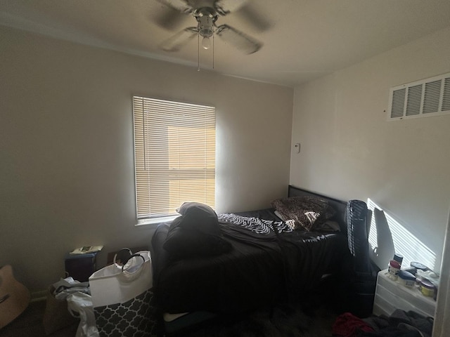 bedroom with multiple windows and ceiling fan