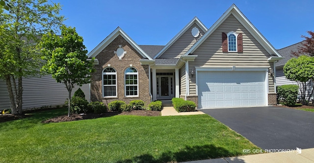 1400 Colchester Ln, Aurora, IL 60505 - traditional home with driveway, brick siding, a front lawn, and a garage