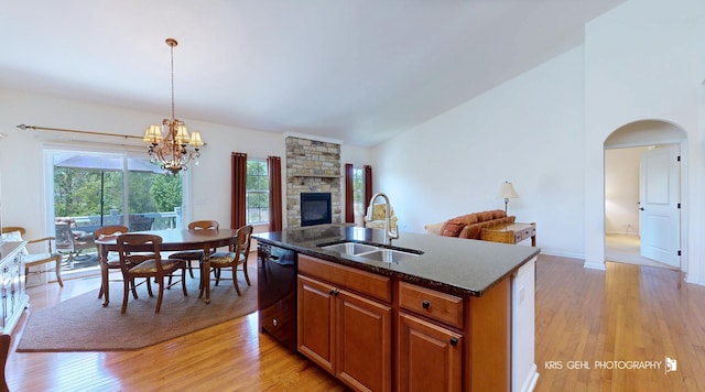 1400 Colchester Ln, Aurora, IL 60505 - kitchen featuring dishwasher, a sink, open floor plan, brown cabinets, and light wood-style floors