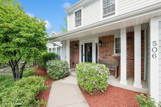 506 Rodney St, Lockport, IL 60441 - property entrance featuring covered porch and brick siding