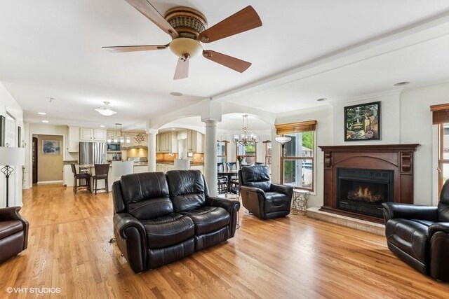 506 Rodney St, Lockport, IL 60441 - living area featuring decorative columns, healthy amount of natural light, a ceiling fan, and light wood finished floors