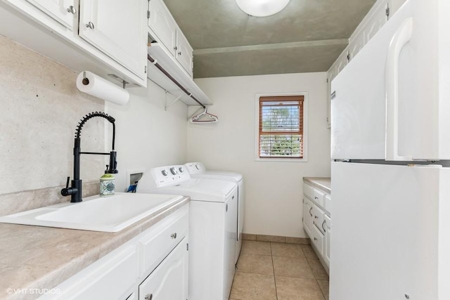 506 Rodney St, Lockport, IL 60441 - laundry area with light tile patterned floors, washer and clothes dryer, cabinet space, and baseboards