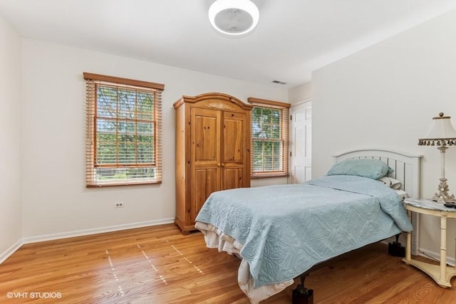 506 Rodney St, Lockport, IL 60441 - bedroom featuring multiple windows, light wood finished floors, and baseboards