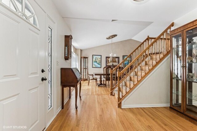 506 Rodney St, Lockport, IL 60441 - foyer with stairs, light wood-type flooring, a chandelier, baseboards, and lofted ceiling