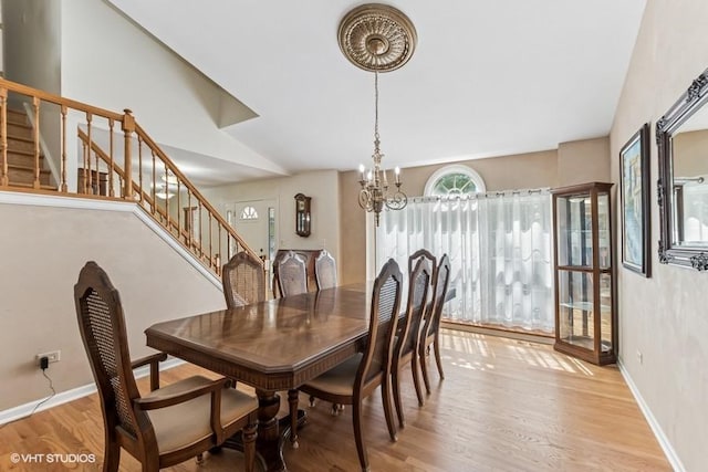 506 Rodney St, Lockport, IL 60441 - dining area with stairs, a chandelier, wood finished floors, and baseboards