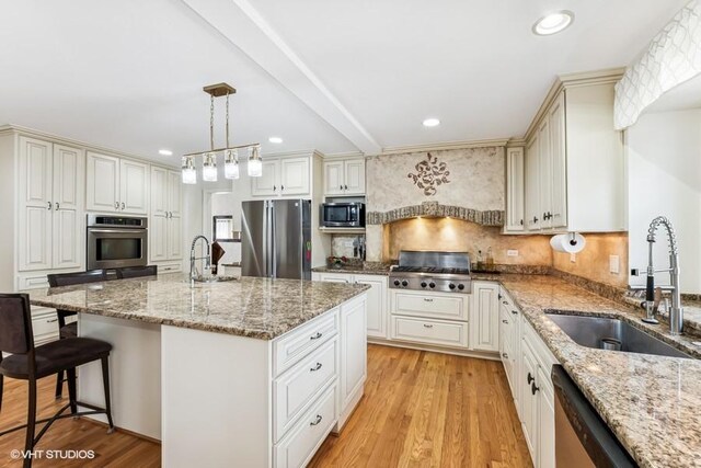 506 Rodney St, Lockport, IL 60441 - kitchen with stainless steel appliances, a sink, light wood-type flooring, light stone counters, and recessed lighting