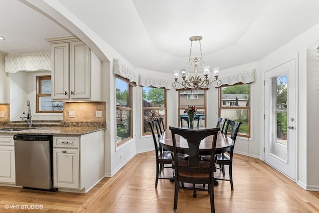 506 Rodney St, Lockport, IL 60441 - dining room featuring a chandelier, light wood finished floors, baseboards, and arched walkways