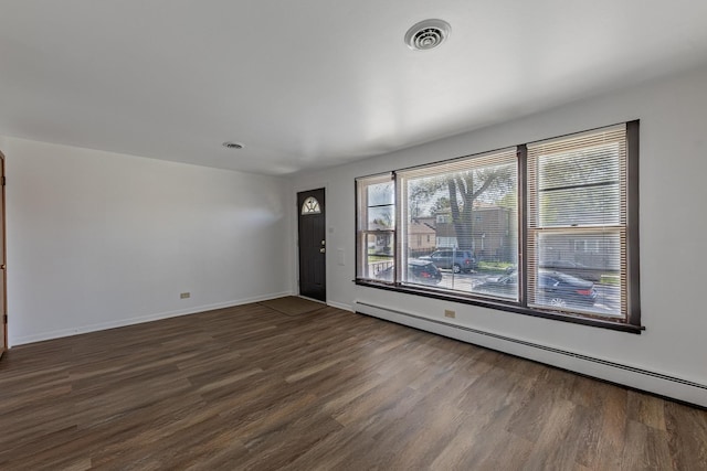 7426 W 64th St, Summit, IL 60501 - unfurnished living room featuring baseboard heating, dark wood-style flooring, and baseboards