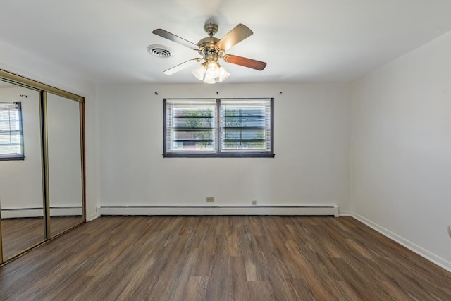 7426 W 64th St, Summit, IL 60501 - unfurnished bedroom with multiple windows, wood finished floors, and a baseboard radiator