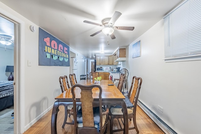 7426 W 64th St, Summit, IL 60501 - dining room with a ceiling fan, baseboard heating, light wood finished floors, and baseboards