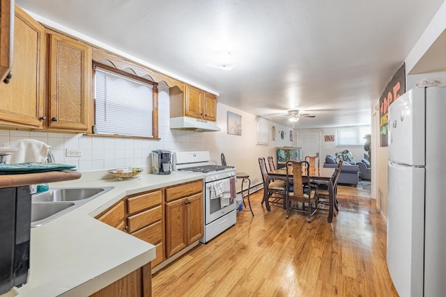 7426 W 64th St, Summit, IL 60501 - kitchen featuring white appliances, under cabinet range hood, a ceiling fan, light wood-style flooring, and tasteful backsplash