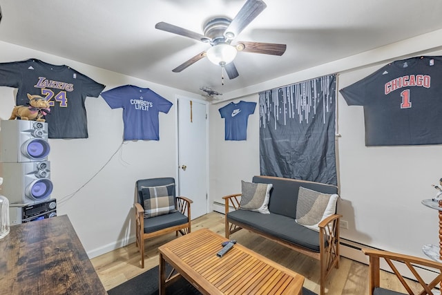 7426 W 64th St, Summit, IL 60501 - sitting room with stacked washing machine and dryer, a baseboard radiator, a ceiling fan, and wood finished floors