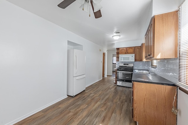7426 W 64th St, Summit, IL 60501 - kitchen featuring white appliances, a sink, baseboards, ceiling fan, and decorative backsplash