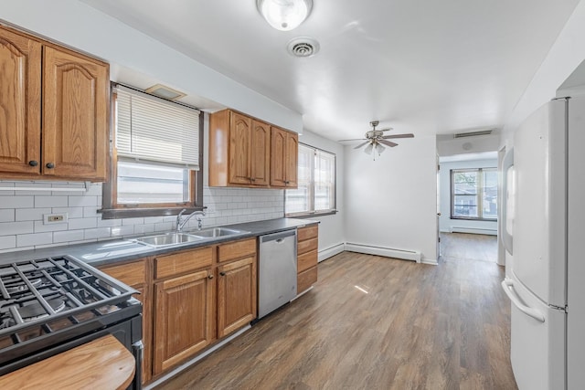 7426 W 64th St, Summit, IL 60501 - kitchen featuring dishwasher, black range with gas stovetop, baseboard heating, freestanding refrigerator, and healthy amount of natural light
