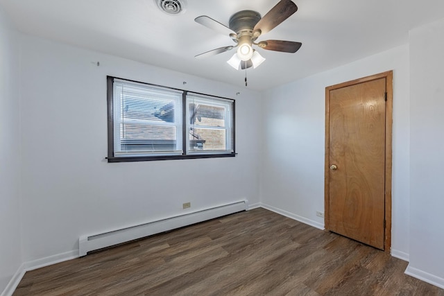 7426 W 64th St, Summit, IL 60501 - empty room featuring baseboard heating, dark wood-type flooring, a ceiling fan, and baseboards