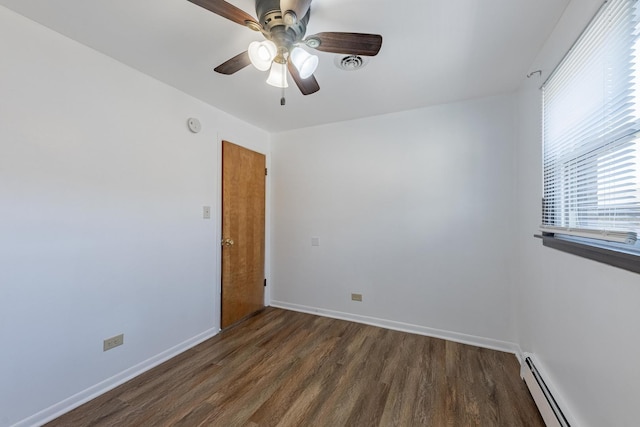 7426 W 64th St, Summit, IL 60501 - spare room featuring a baseboard heating unit, wood finished floors, ceiling fan, and baseboards