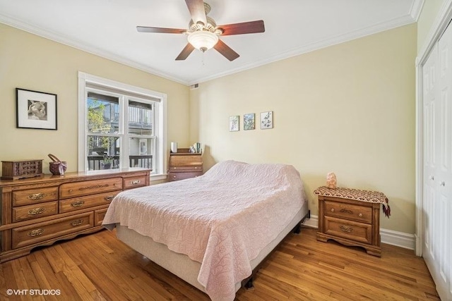 4444 N Wolcott Ave Unit 2A, Chicago, IL 60640 - bedroom with a closet, ornamental molding, light wood-type flooring, baseboards, and ceiling fan