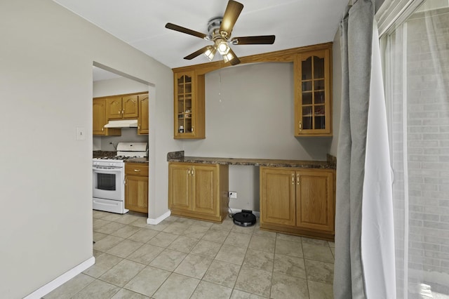 kitchen with white range with gas stovetop, under cabinet range hood, a ceiling fan, and brown cabinetry