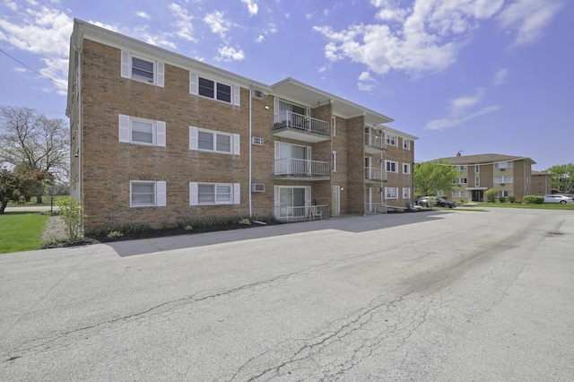 view of apartment building / complex with uncovered parking