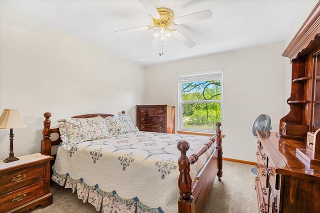 carpeted bedroom featuring baseboards and a ceiling fan