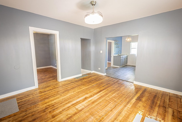 684 S Gordon Ave, Kankakee, IL 60901 - spare room featuring wood finished floors, a sink, and baseboards