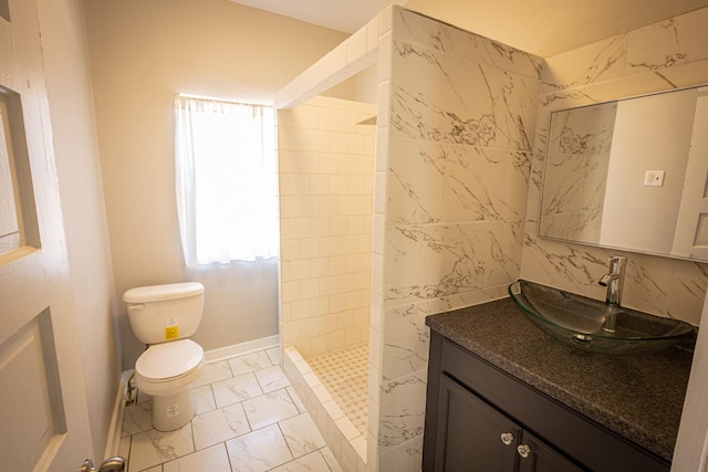 684 S Gordon Ave, Kankakee, IL 60901 - bathroom featuring marble finish flooring, a tile shower, toilet, vanity, and baseboards