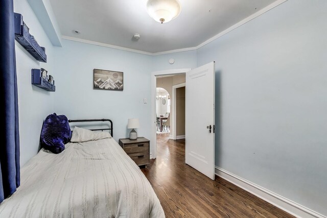 6167 N Naper Ave, Chicago, IL 60631 - bedroom featuring crown molding, wood finished floors, baseboards, and a chandelier