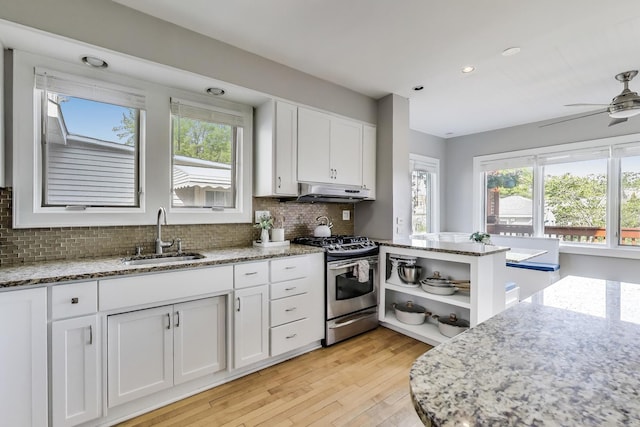 6167 N Naper Ave, Chicago, IL 60631 - kitchen featuring a sink, gas range, under cabinet range hood, white cabinetry, and open shelves