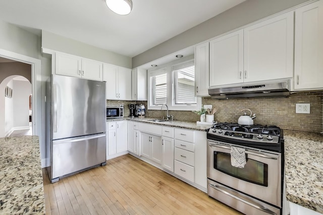 6167 N Naper Ave, Chicago, IL 60631 - kitchen with stainless steel appliances, under cabinet range hood, arched walkways, and white cabinets