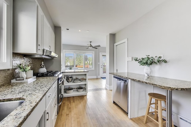 6167 N Naper Ave, Chicago, IL 60631 - kitchen with stainless steel appliances, decorative backsplash, light wood-type flooring, white cabinets, and a ceiling fan