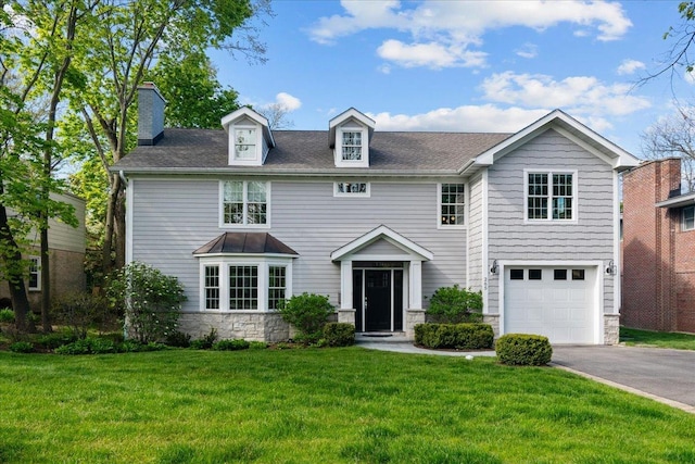 265 Ivy Ln, Highland Park, IL 60035 - view of front of house with stone siding, asphalt driveway, a front lawn, a garage, and a chimney