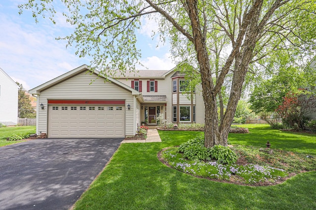 43 Mohawk St, Cary, IL 60013 - traditional-style home featuring asphalt driveway and an attached garage