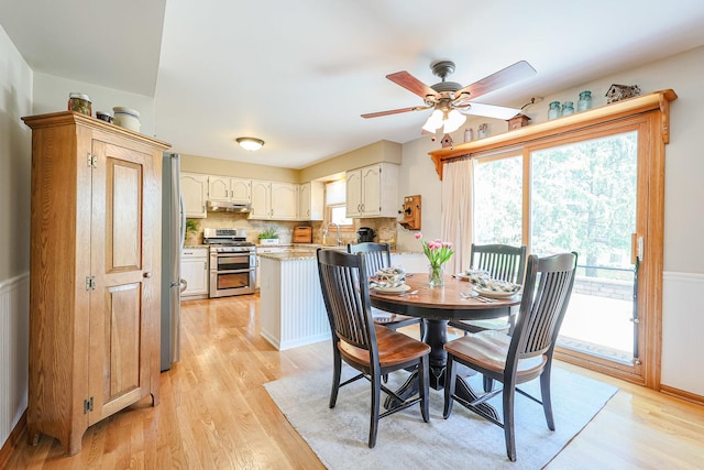 43 Mohawk St, Cary, IL 60013 - dining room featuring light wood-style floors, plenty of natural light, ceiling fan, and a wainscoted wall