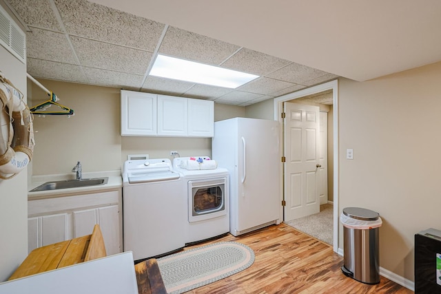 43 Mohawk St, Cary, IL 60013 - washroom featuring cabinet space, washer and dryer, and light wood-type flooring