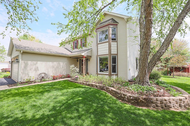 43 Mohawk St, Cary, IL 60013 - view of front facade with a front yard and an attached garage