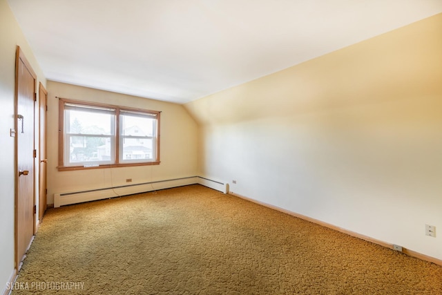 additional living space with a baseboard radiator, carpet, lofted ceiling, and baseboards