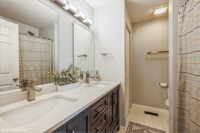 2140 Colchester Ave, Hoffman Estates, IL 60192 - bathroom with double vanity, tile patterned flooring, toilet, and baseboards
