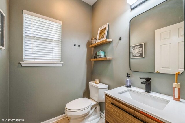 2140 Colchester Ave, Hoffman Estates, IL 60192 - bathroom with toilet, vanity, and baseboards