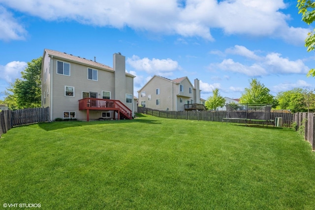 2140 Colchester Ave, Hoffman Estates, IL 60192 - rear view of house featuring a trampoline, a wooden deck, stairs, and a chimney
