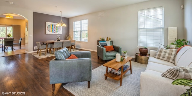 2140 Colchester Ave, Hoffman Estates, IL 60192 - living area featuring arched walkways, wood finished floors, a chandelier, and baseboards