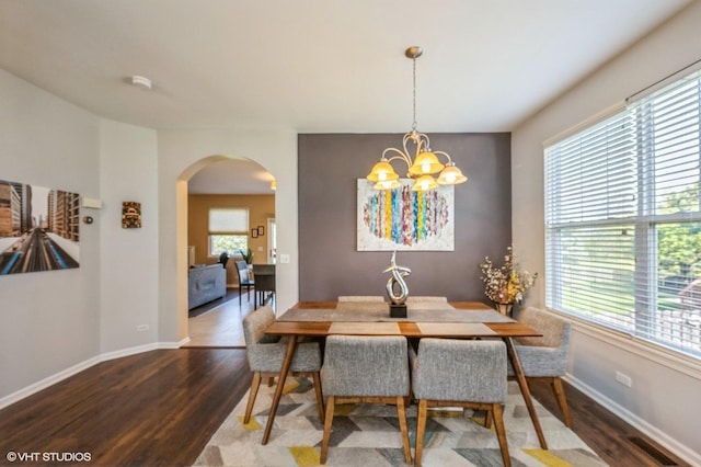 2140 Colchester Ave, Hoffman Estates, IL 60192 - dining area with wood finished floors, arched walkways, a chandelier, and baseboards