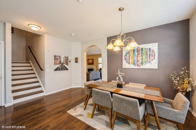 2140 Colchester Ave, Hoffman Estates, IL 60192 - dining area with wood finished floors, arched walkways, stairs, baseboards, and a chandelier