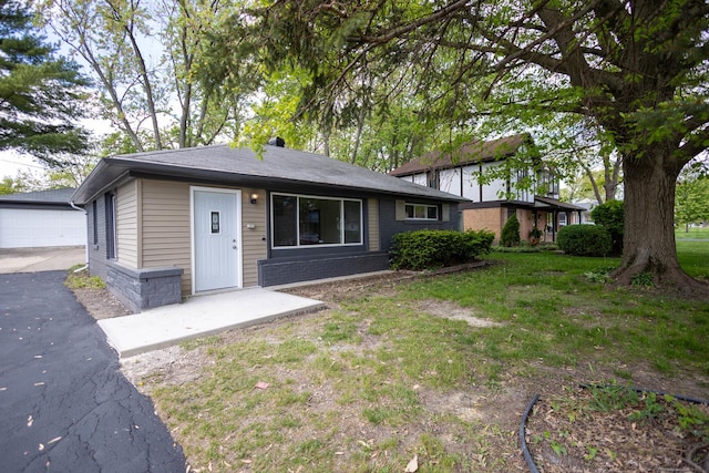239 Marquette St, Park Forest, IL 60466 - view of front of home featuring an outbuilding, a detached garage, and a front yard