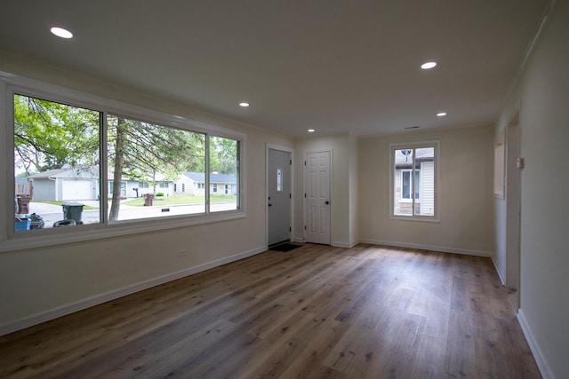 239 Marquette St, Park Forest, IL 60466 - empty room with healthy amount of natural light, wood finished floors, baseboards, recessed lighting, and crown molding