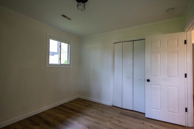 239 Marquette St, Park Forest, IL 60466 - unfurnished bedroom featuring wood finished floors, ornamental molding, baseboards, and a closet