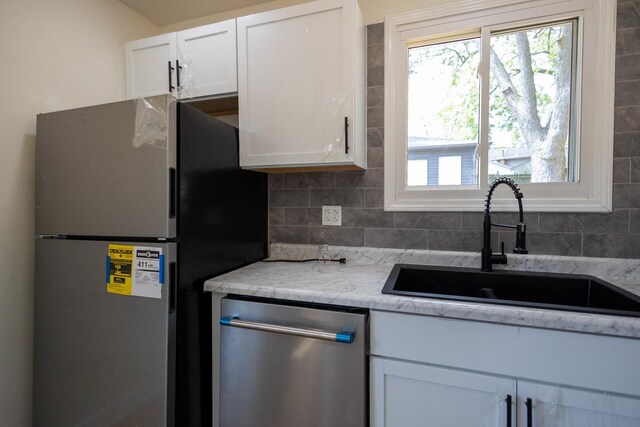 239 Marquette St, Park Forest, IL 60466 - kitchen featuring stainless steel appliances, a sink, white cabinets, and backsplash