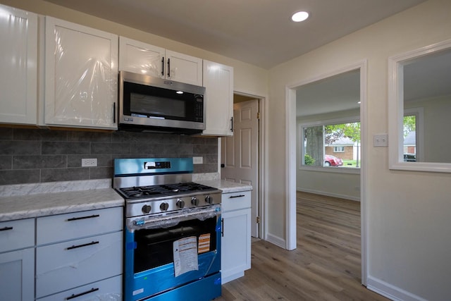 239 Marquette St, Park Forest, IL 60466 - kitchen with appliances with stainless steel finishes, tasteful backsplash, light wood-type flooring, baseboards, and recessed lighting